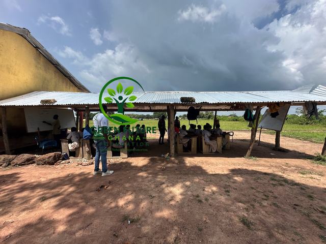 An open-sided school shelter under a stormy sky