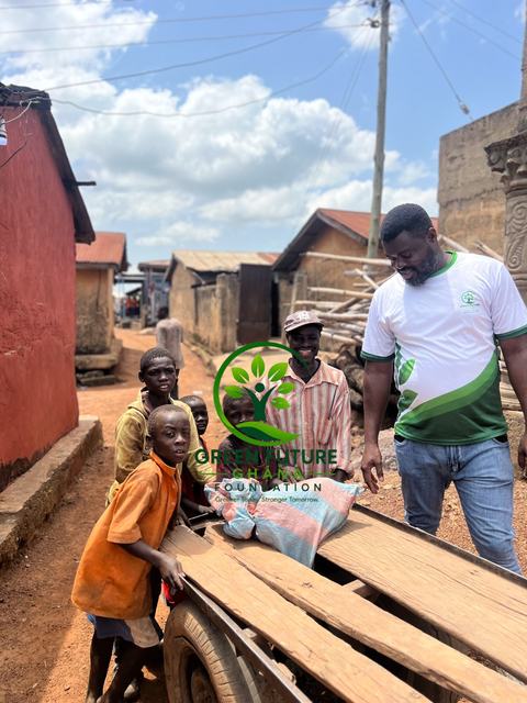 A foundation volunteer with local people and children beside a wooden cart